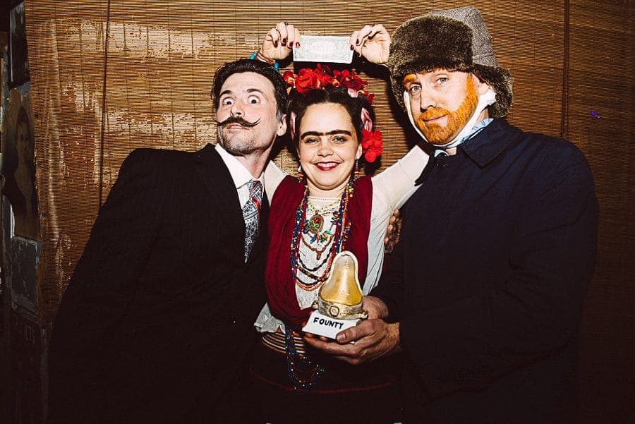 Artists dressed as Dalí, Frida Kahlo, and Van Gogh posing with a Founty