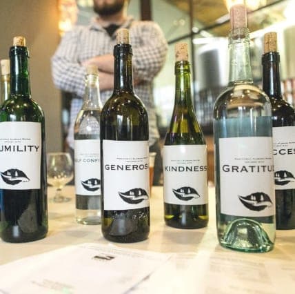 Positively Alabama Water bottles labeled Humility, Generosity, Kindness, and Gratitude