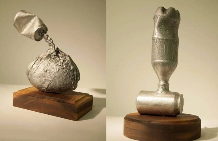 Two cast-metal sculptures made from trash found at the lake, on wooden bases